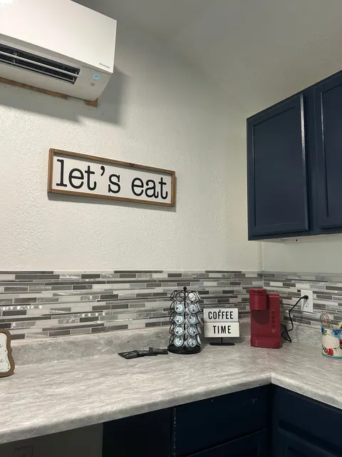 Kitchen counter with coffee maker, toaster, and blue cabinets